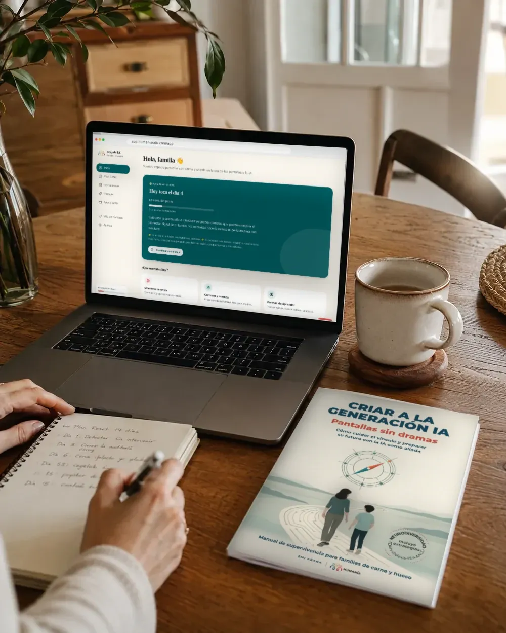 Persona apuntando el Plan Reset junto al portátil con la app Brújula IA y la guía